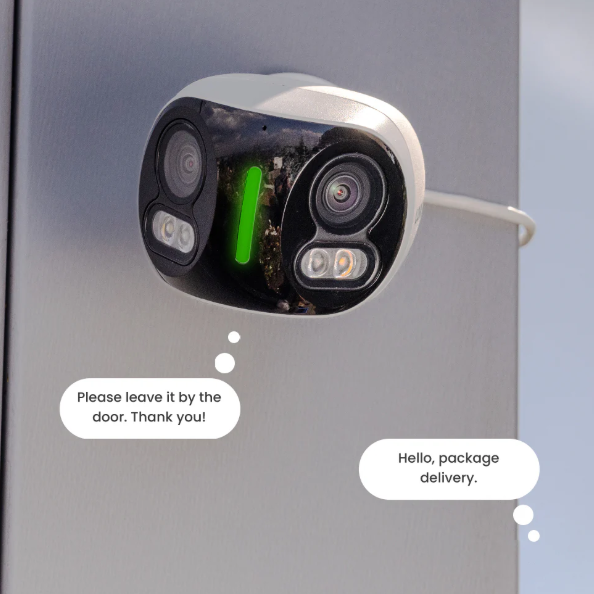 Lorex Fusion 4K dual-lens outdoor security camera mounted on a wall, featuring smart audio response with speech bubbles saying “Hello, package delivery” and “Please leave it by the door. Thank you!”