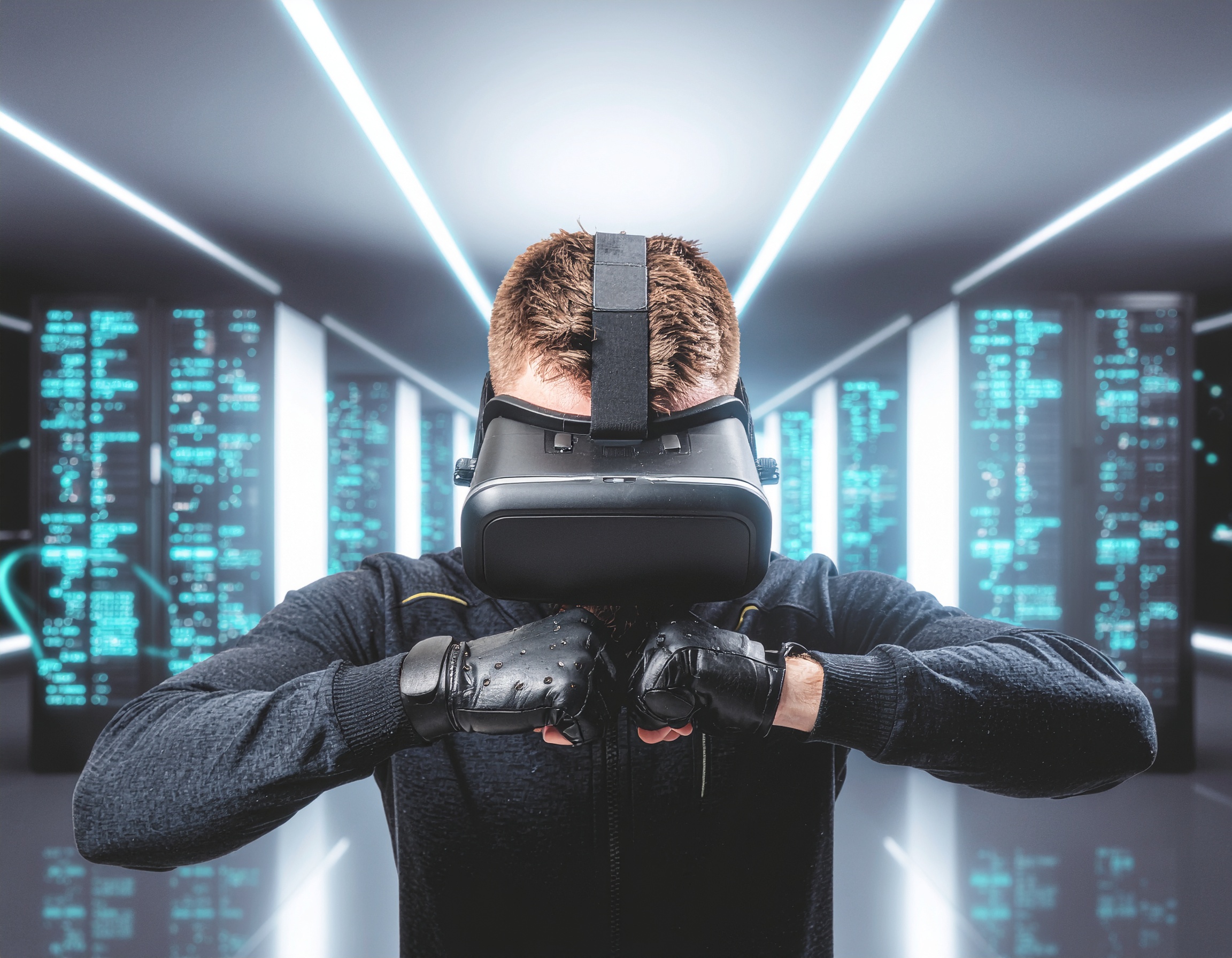 Man wearing a VR headset and haptic gloves in a futuristic data center, engaging in a virtual environment with glowing blue server racks in the background.